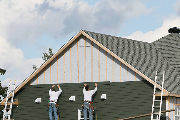 Professional Siding technician working in Levittown, NY
